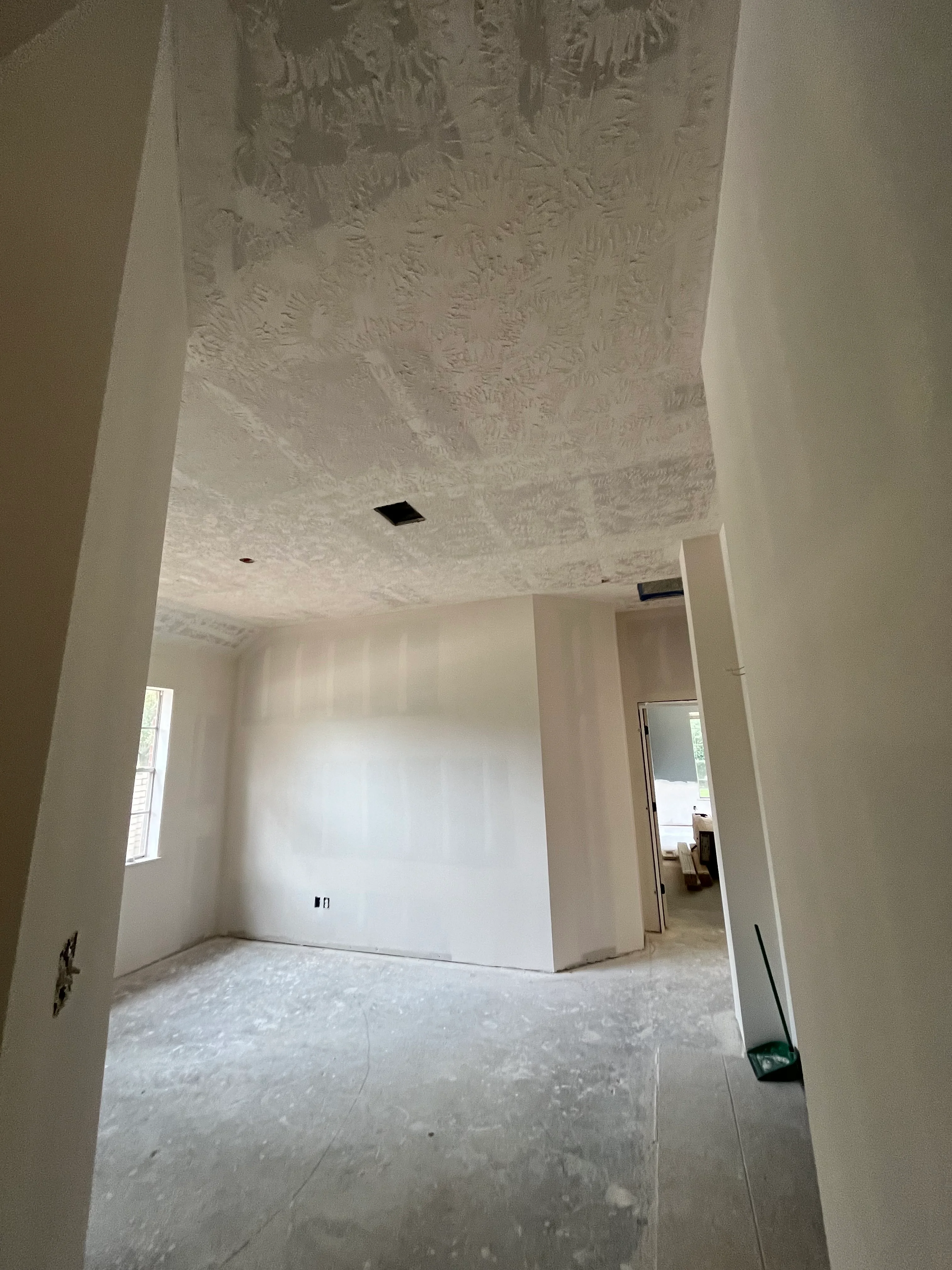 Interior drywall and textured ceiling installation in residential remodel project
