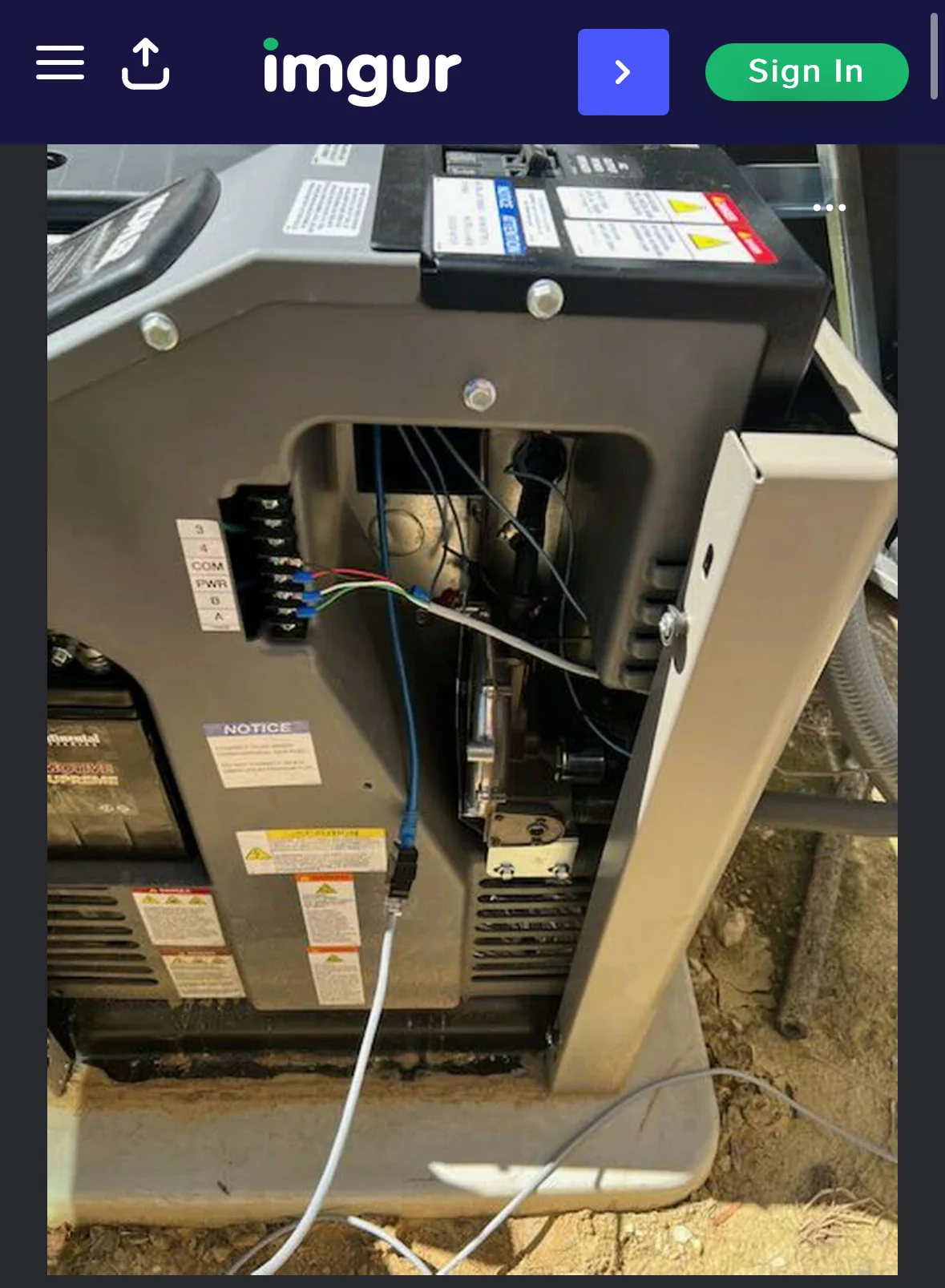 HVAC air handler unit with refrigerant lines, electrical wiring, and safety labels installed