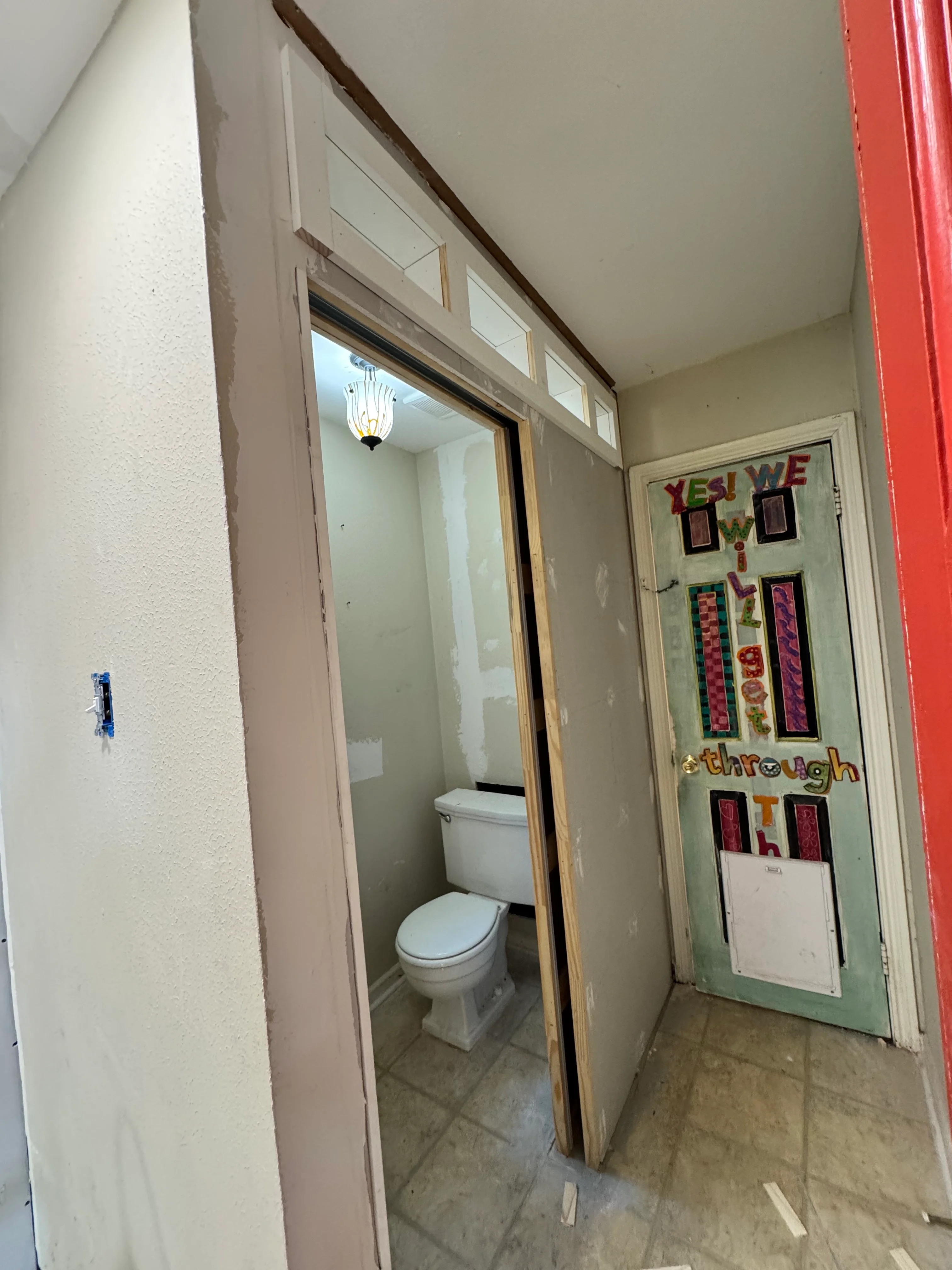Bathroom remodel showing new vanity, mirrored cabinet, and updated drywall in Spring home