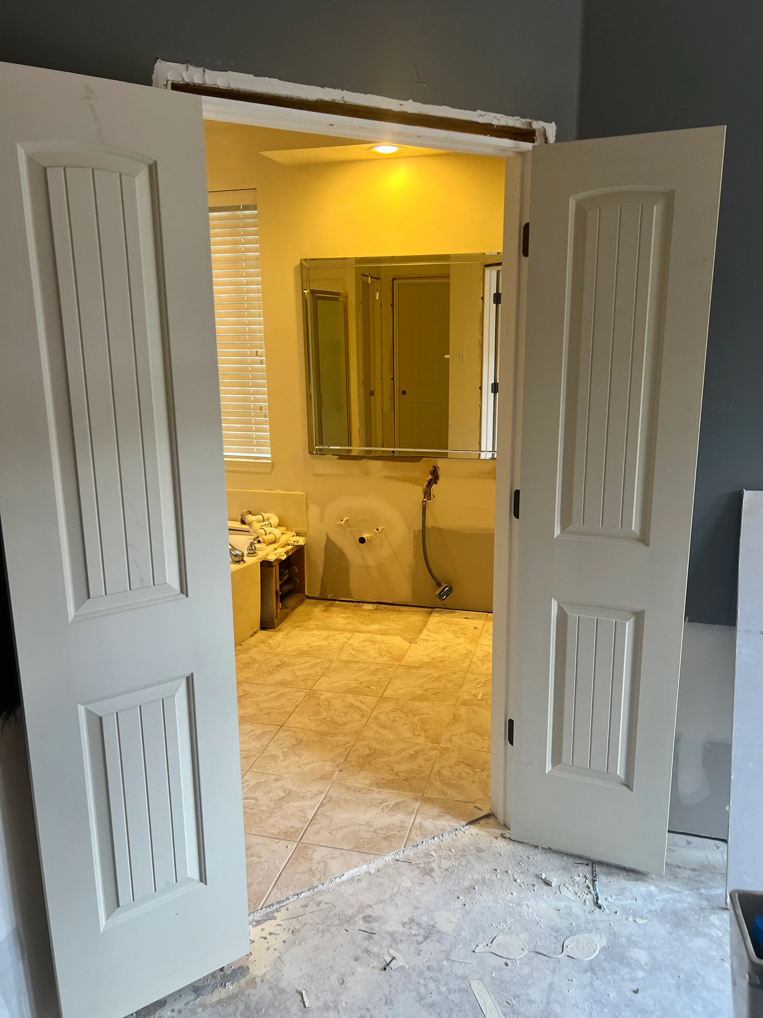 Newly remodeled bathroom with yellow walls, tile flooring, and updated fixtures