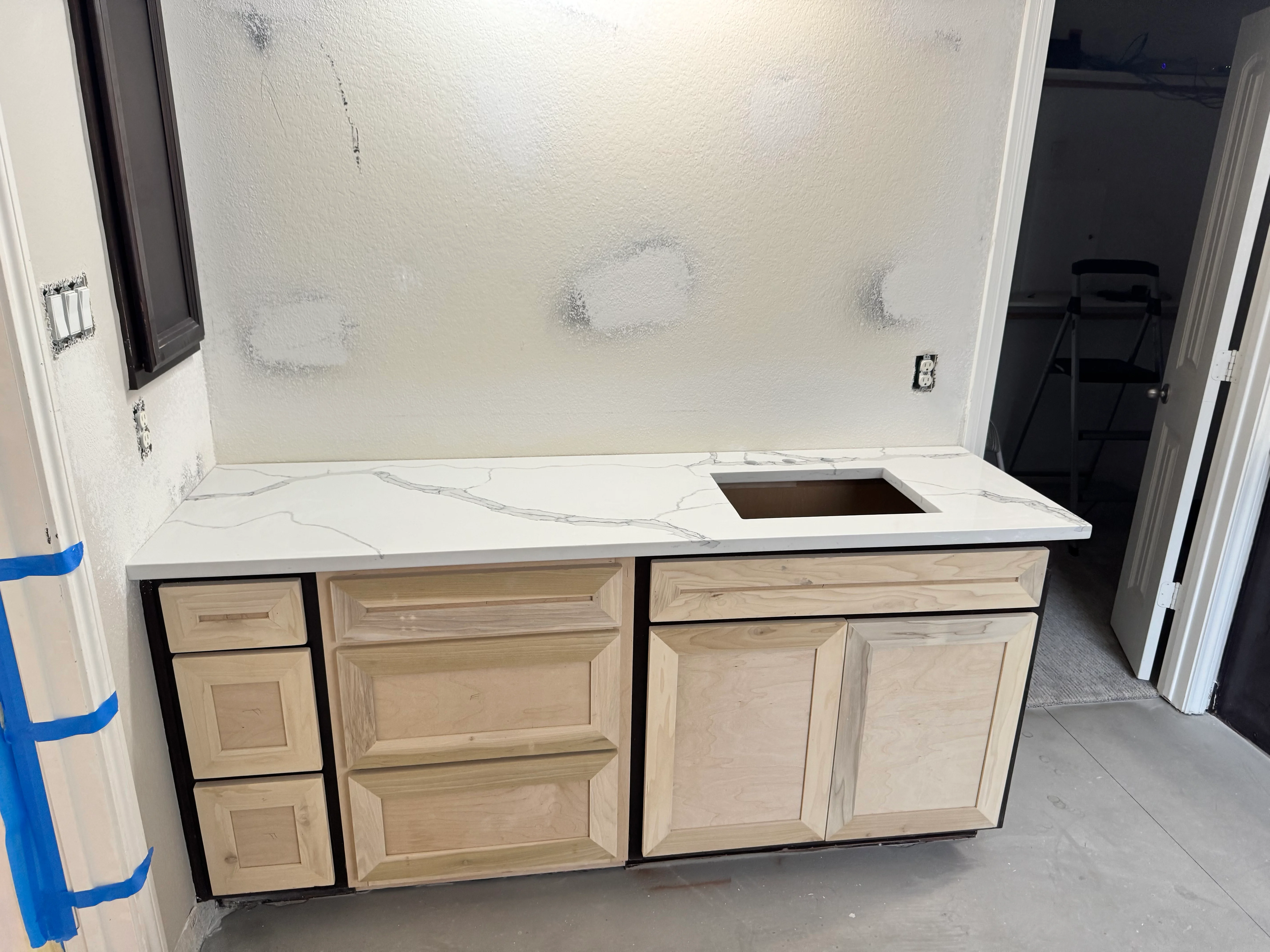Kitchen cabinet and countertop installation with marble quartz counter and wood cabinetry