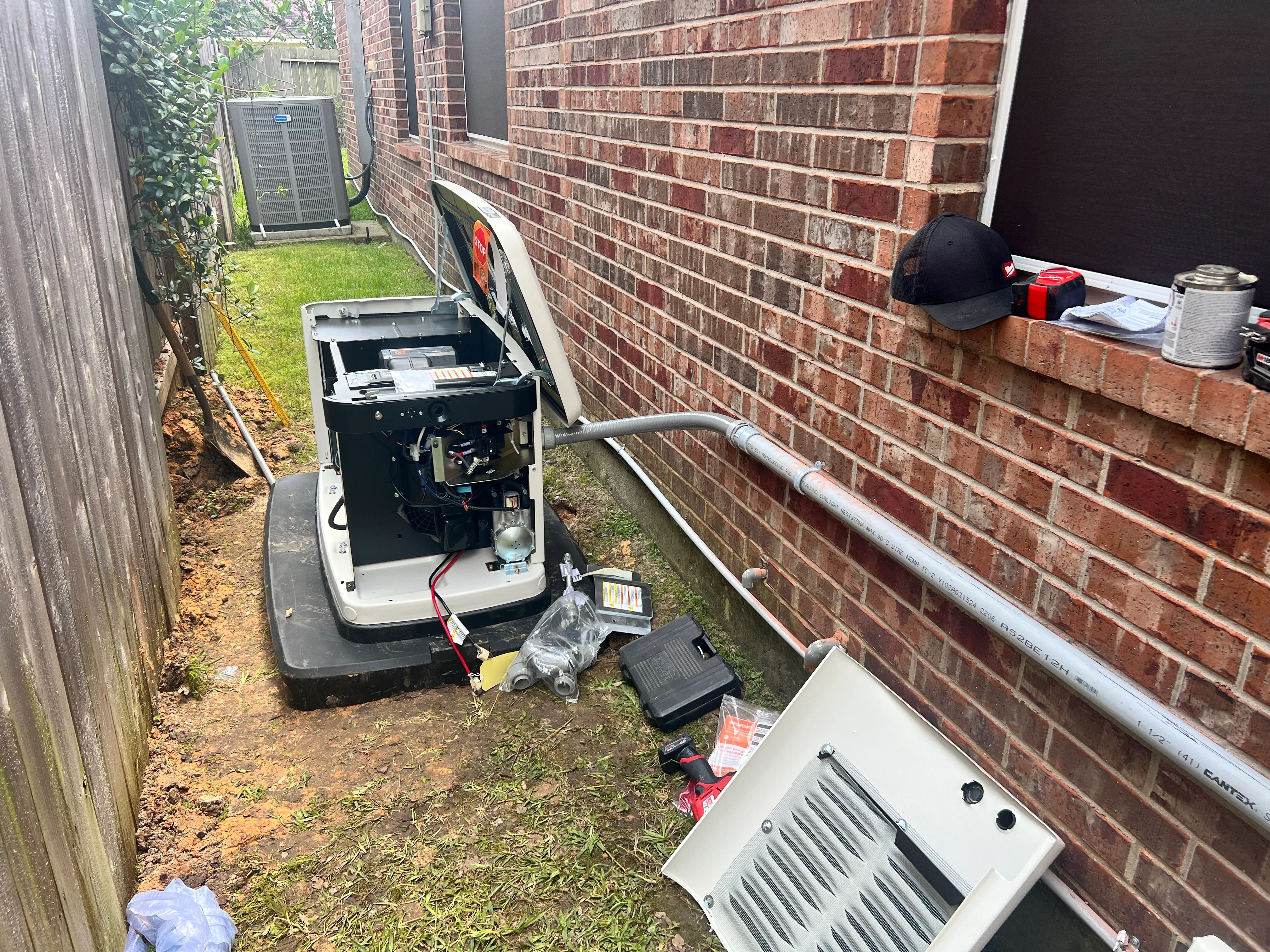 HVAC unit installation with ductwork and components in residential side yard